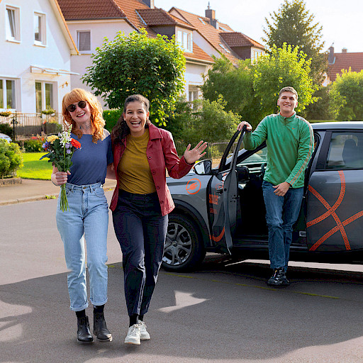 Gruppe junger Leute mietet Carsharing Auto